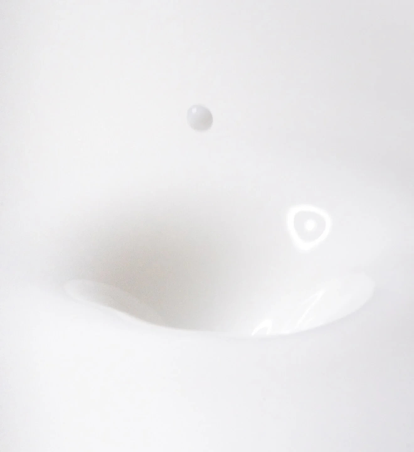 Close-up of a smooth, pale skincare texture