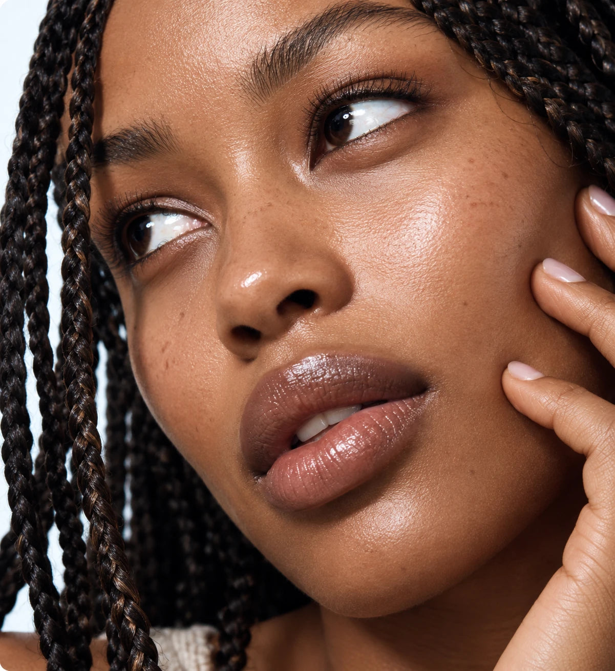 Close-up of a woman gently touching her cheek