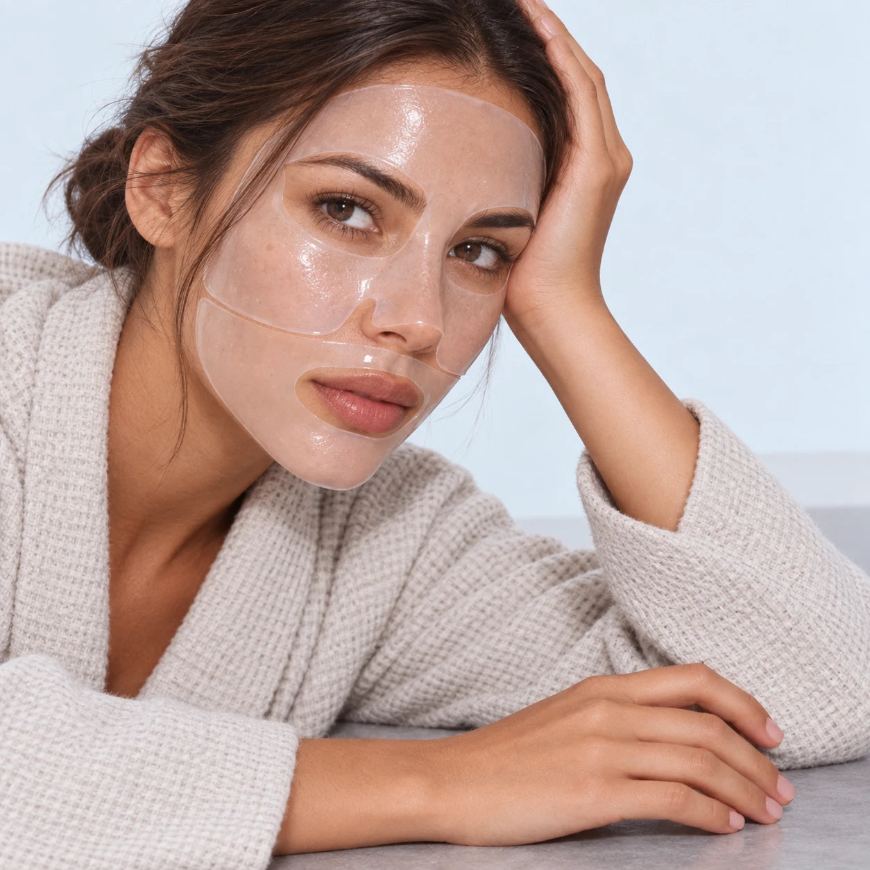 Woman in a light knit wearing a translucent hydrogel face mask