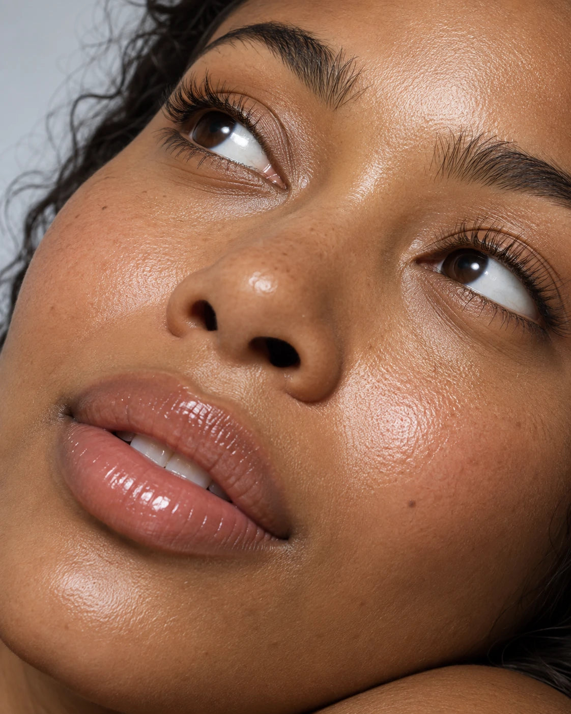 Close-up portrait of a woman with hydrated, dewy-looking skin