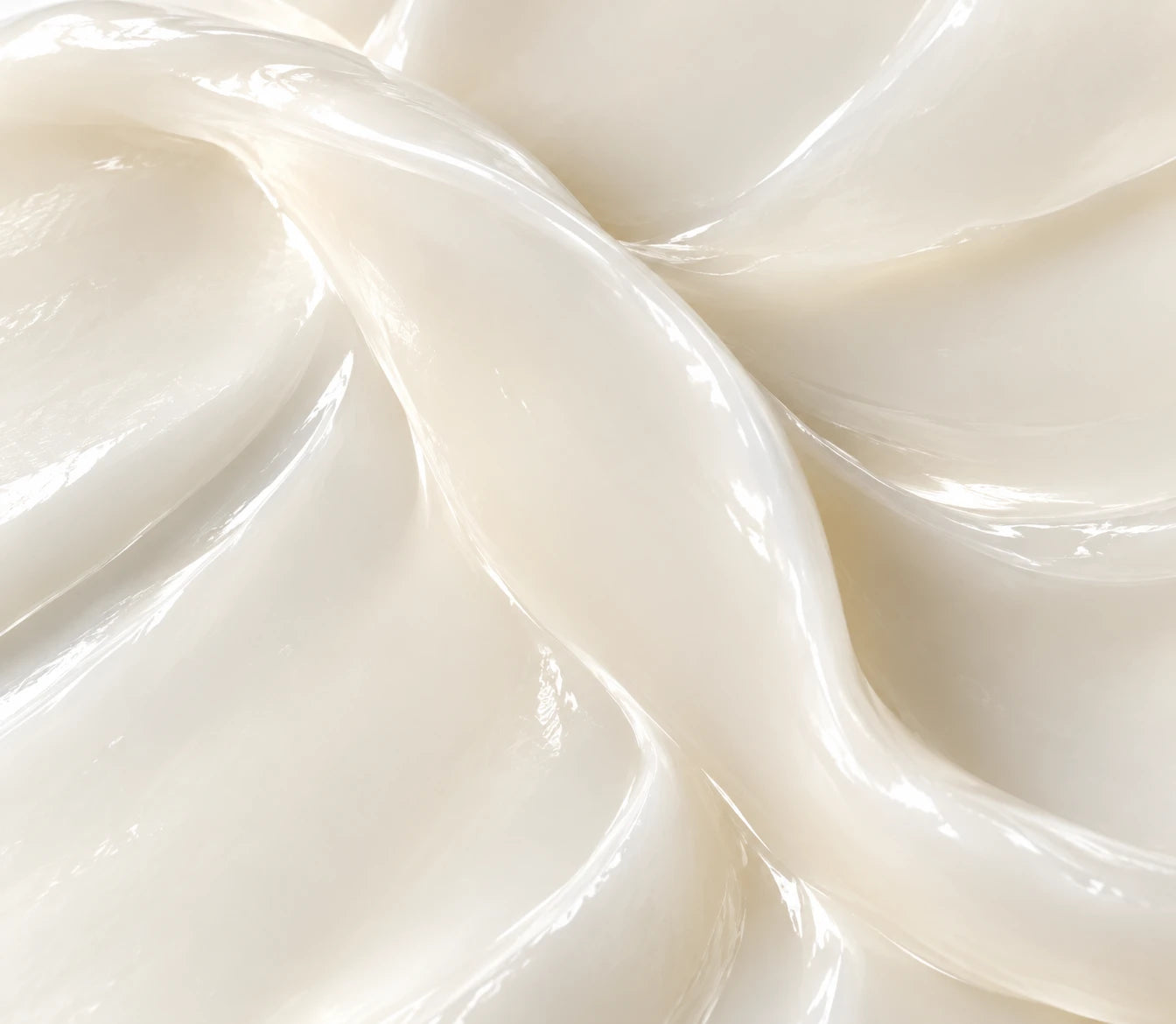 Close-up of glossy ivory skincare texture in soft folds