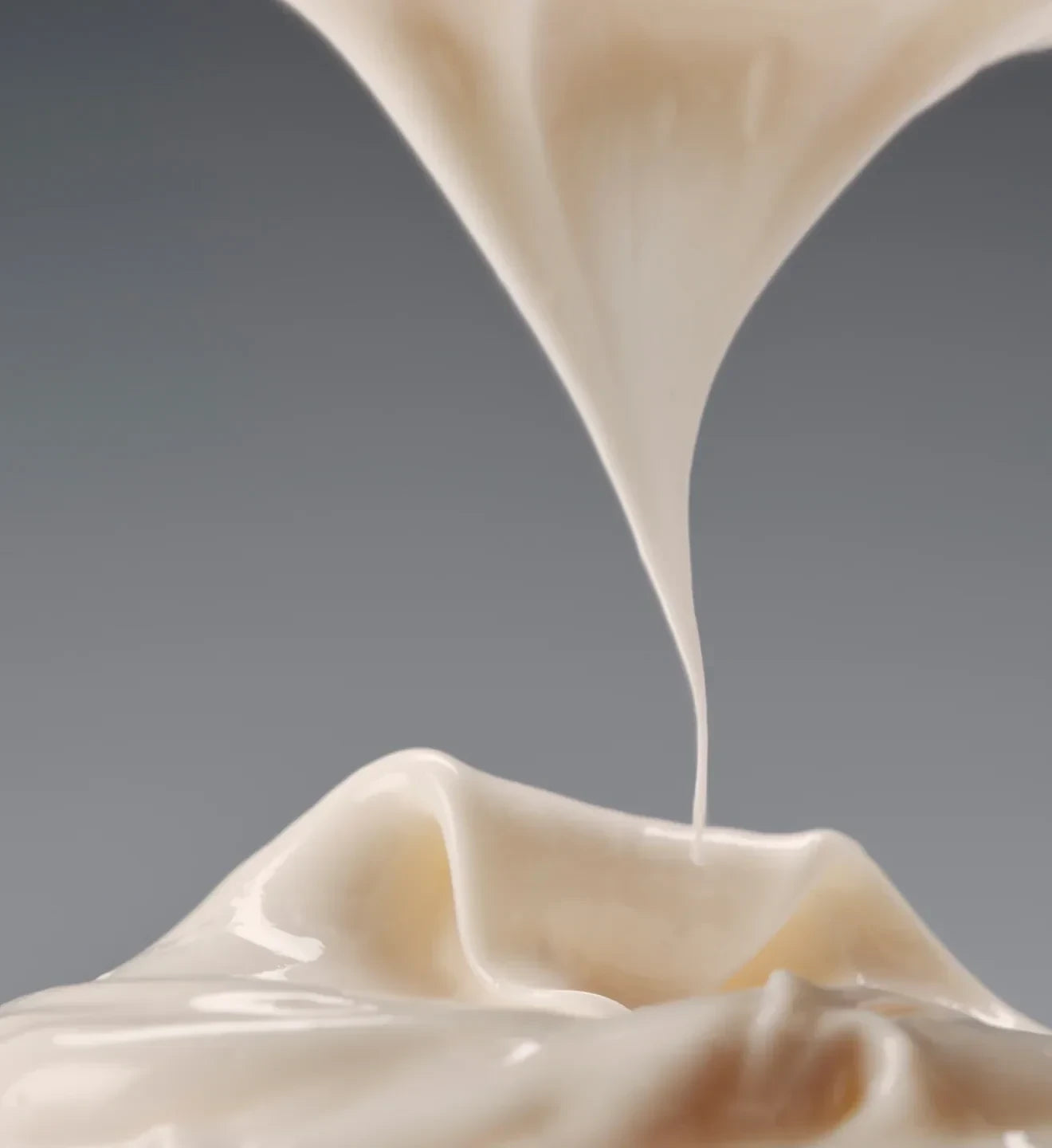 Silky cream texture against a grey background