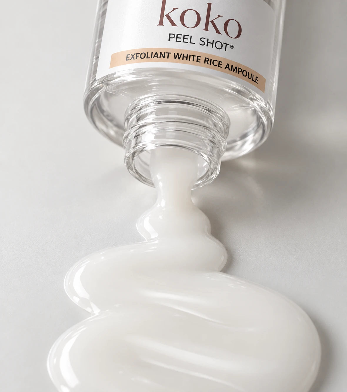 White Rice Ampoule flowing from an open Koko bottle