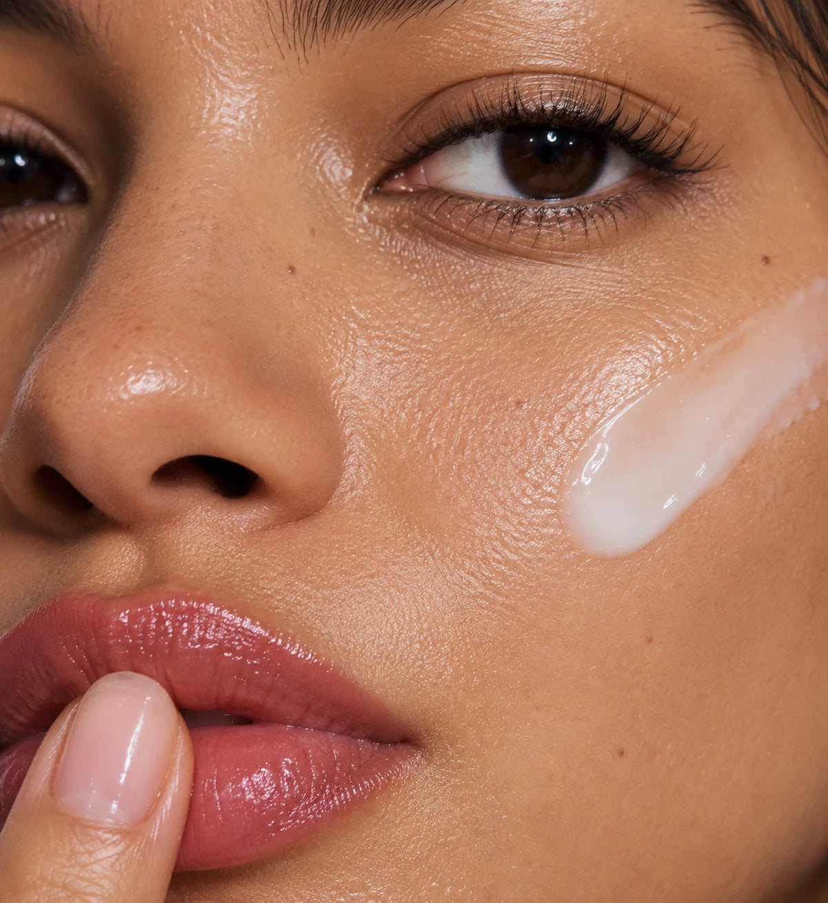 Close-up of skin with serum spread across the cheek