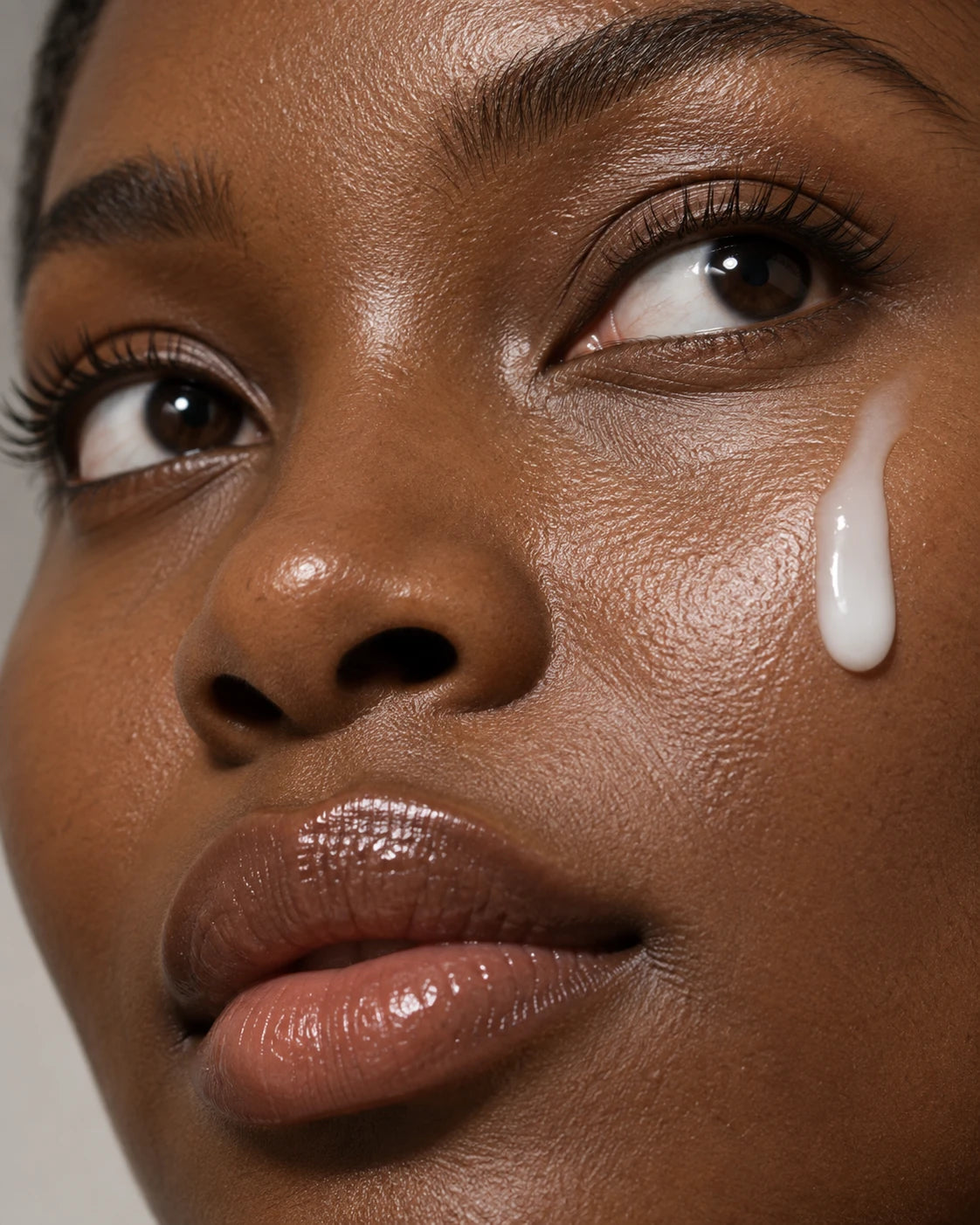 Close-up of skin with a drop of serum on the cheek